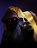 A mysterious hooded figure with glowing eyes reaches out to the viewer
